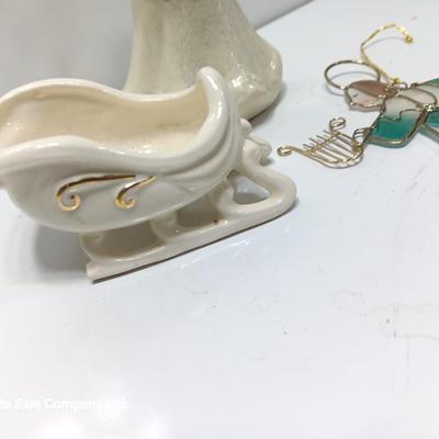 Porcelain angel with white and gold sleigh and blue angel with harp ornament