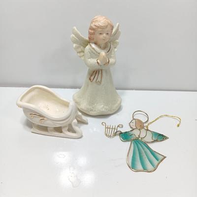 Porcelain angel with white and gold sleigh and blue angel with harp ornament