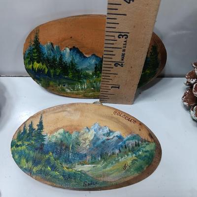 Two hand painted Colorado scenery ornaments on wood and two other Christmas ornaments with pine cones