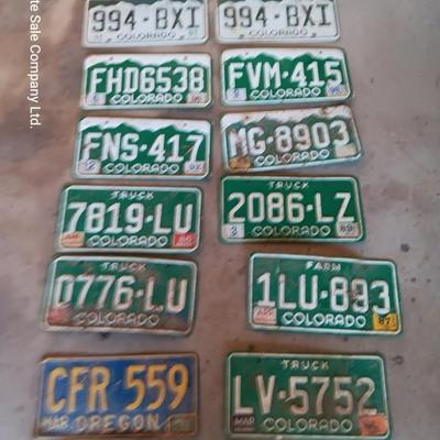 Newer Colorado License plates with annual stickers and one Oregon plate