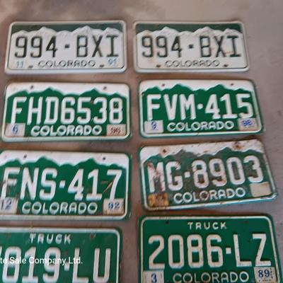 Newer Colorado License plates with annual stickers and one Oregon plate