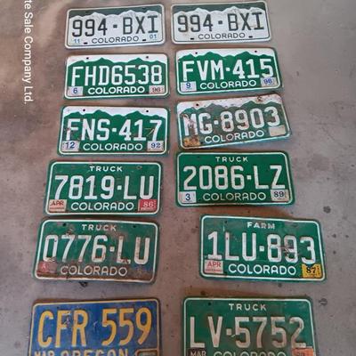 Newer Colorado License plates with annual stickers and one Oregon plate