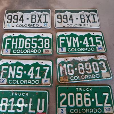Newer Colorado License plates with annual stickers and one Oregon plate