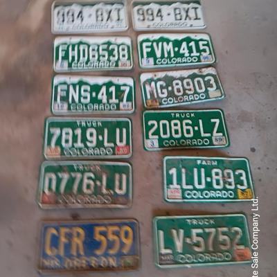 Newer Colorado License plates with annual stickers and one Oregon plate