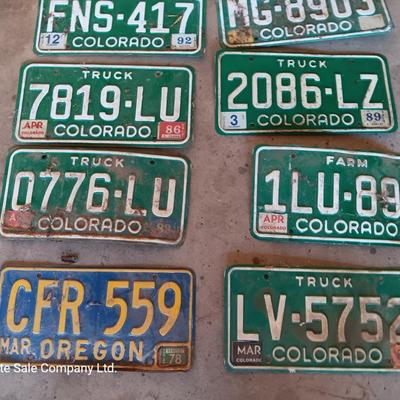 Newer Colorado License plates with annual stickers and one Oregon plate
