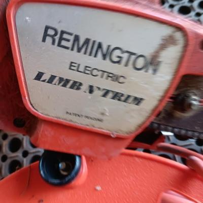 Small Remington Electric Limb n' Trim 8" chain saw with extension cord in cord spool