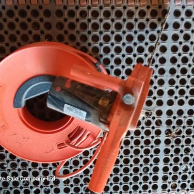 Small Remington Electric Limb n' Trim 8" chain saw with extension cord in cord spool