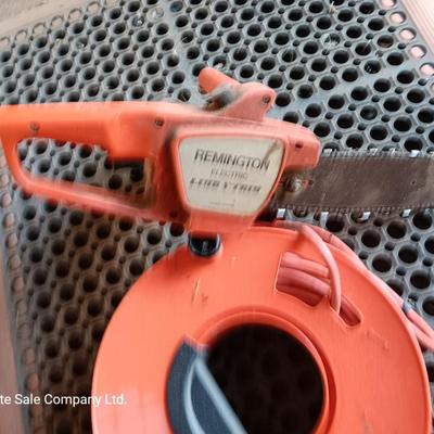 Small Remington Electric Limb n' Trim 8" chain saw with extension cord in cord spool