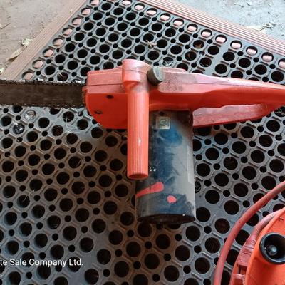 Small Remington Electric Limb n' Trim 8" chain saw with extension cord in cord spool