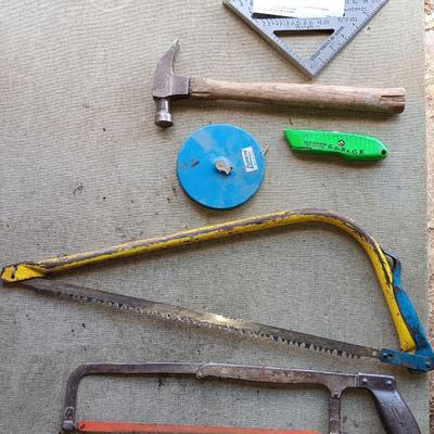 Assortment of tools - Bow saw- Hack saw - cloth measuring tape - hammer - and more