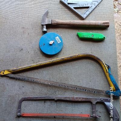 Assortment of tools - Bow saw- Hack saw - cloth measuring tape - hammer - and more