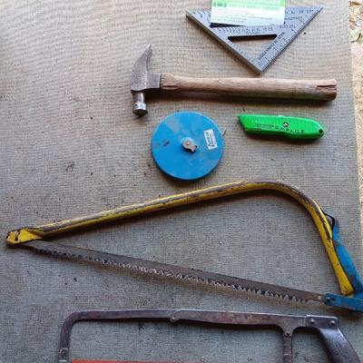 Assortment of tools - Bow saw- Hack saw - cloth measuring tape - hammer - and more