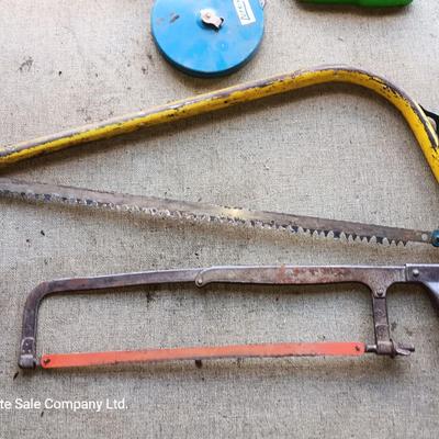 Assortment of tools - Bow saw- Hack saw - cloth measuring tape - hammer - and more