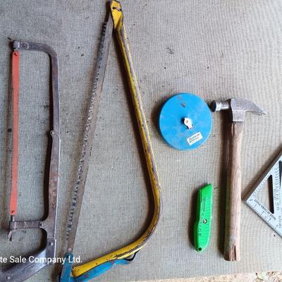 Assortment of tools - Bow saw- Hack saw - cloth measuring tape - hammer - and more