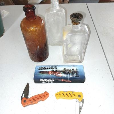 Three vintage bottles two small pocketknives and a new Tactical Frost cutlery Paratrooper Knife