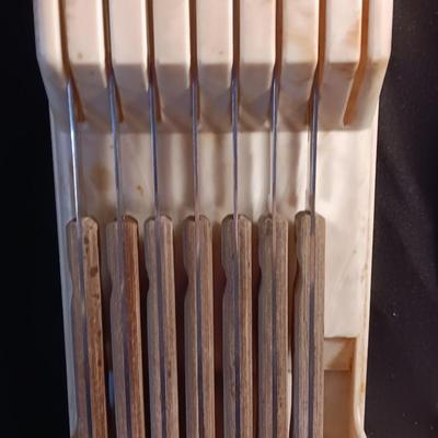 Blue enamelware dish with a set of vintage Zylco Freeze knives in a hanging bakelite case