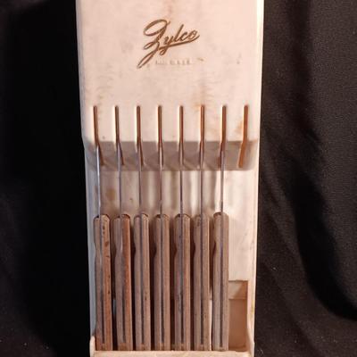 Blue enamelware dish with a set of vintage Zylco Freeze knives in a hanging bakelite case