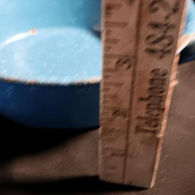 Blue enamelware dish with a set of vintage Zylco Freeze knives in a hanging bakelite case