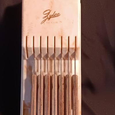 Blue enamelware dish with a set of vintage Zylco Freeze knives in a hanging bakelite case