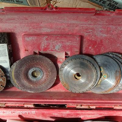 Red plastic toolbox with an assortment of tools and blades