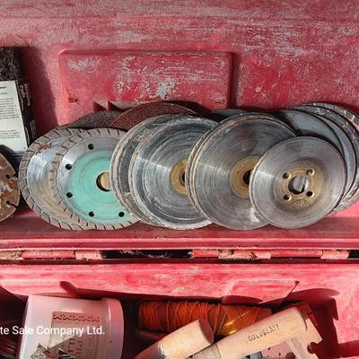 Red plastic toolbox with an assortment of tools and blades