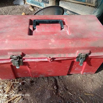 Red plastic toolbox with an assortment of tools and blades