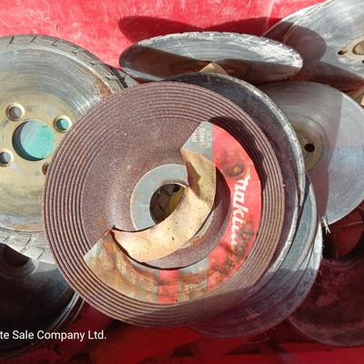 Red plastic toolbox with an assortment of tools and blades