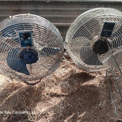 Two metal guard steel framed free standing electric fans