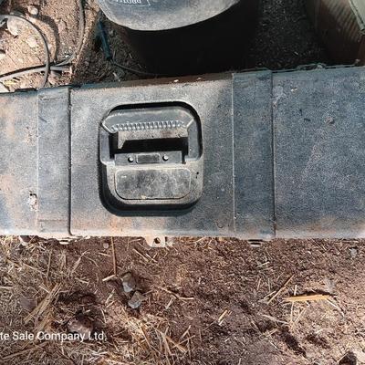 Black plastic toolbox with an assortment of tools