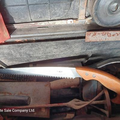 Black plastic toolbox with an assortment of tools