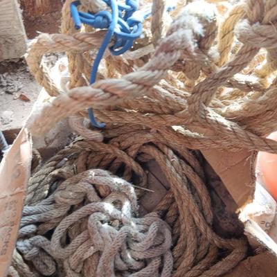 4 orange traffic cones and an assorment of different sized rope