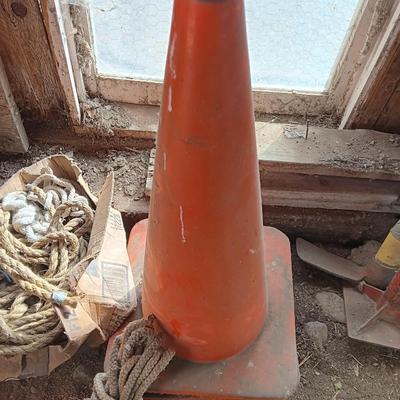 4 orange traffic cones and an assorment of different sized rope
