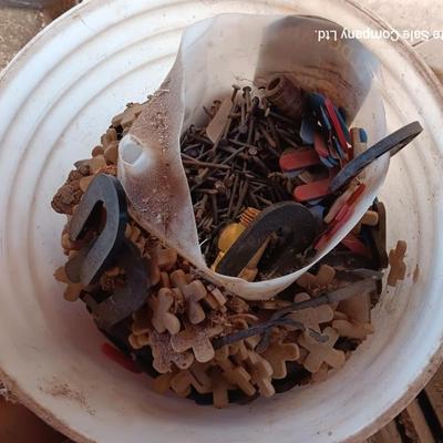 Box of dark colored tile with buckets of tile spacers and other hardware