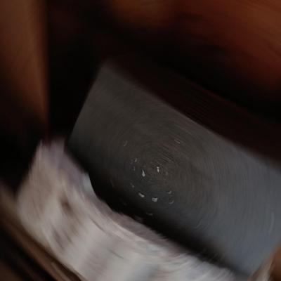 Box of dark colored tile with buckets of tile spacers and other hardware