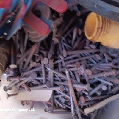 Box of dark colored tile with buckets of tile spacers and other hardware