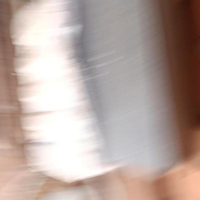 Box of dark colored tile with buckets of tile spacers and other hardware