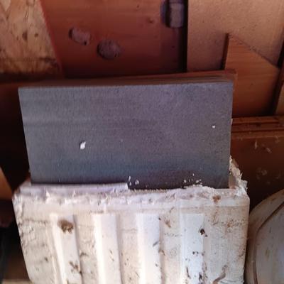 Box of dark colored tile with buckets of tile spacers and other hardware