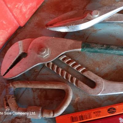 Red plastic toolbox with a variety of tools