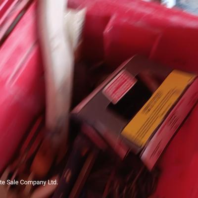 Red plastic toolbox with a variety of tools