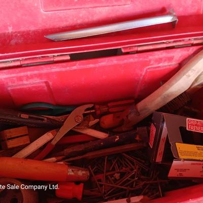 Red plastic toolbox with a variety of tools