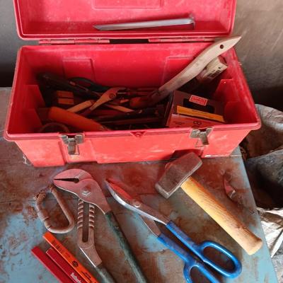 Red plastic toolbox with a variety of tools