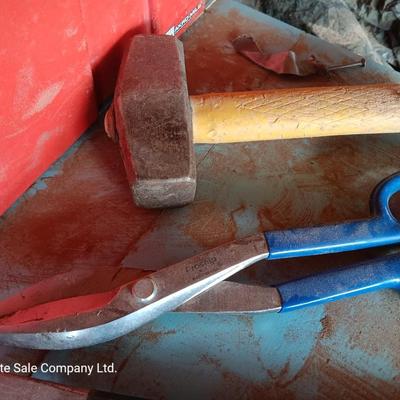 Red plastic toolbox with a variety of tools