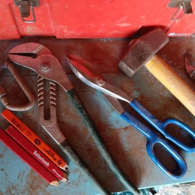Red plastic toolbox with a variety of tools