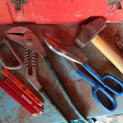 Red plastic toolbox with a variety of tools