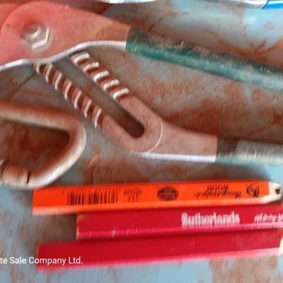 Red plastic toolbox with a variety of tools