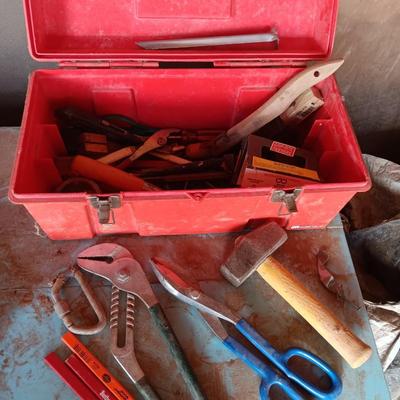 Red plastic toolbox with a variety of tools