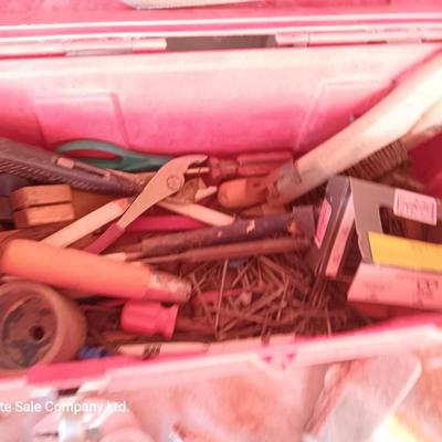 Red plastic toolbox with a variety of tools