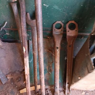 Antique tools - handmade post pounder - prybars - and an assortment of other steel tools