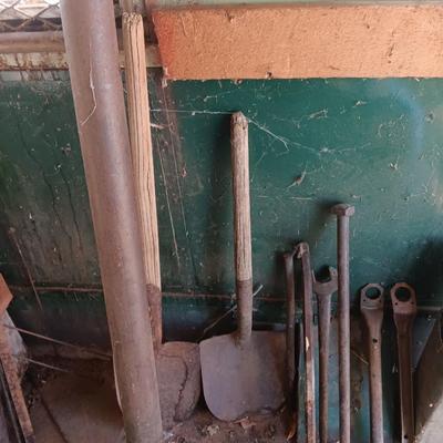 Antique tools - handmade post pounder - prybars - and an assortment of other steel tools