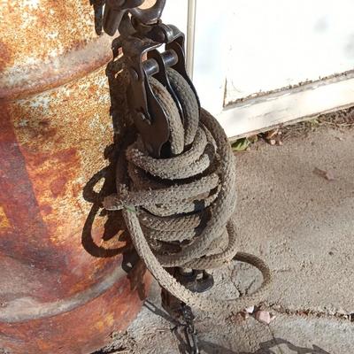 Metal Conoco barrel and a unique steel antique pully / block and tackle